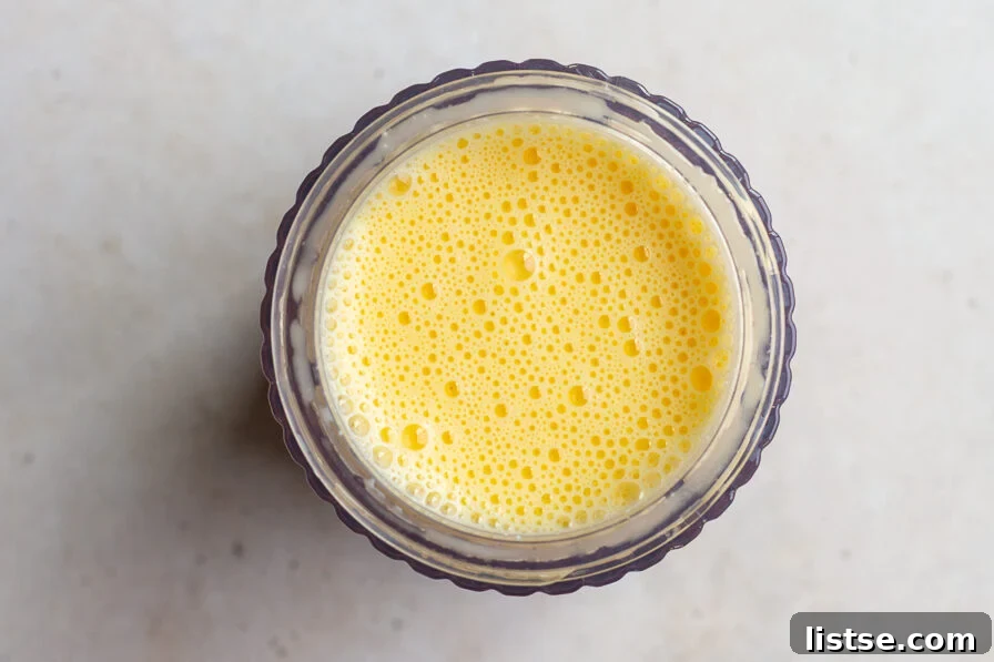 Blended eggs and cottage cheese mixture in a blender base, ready to be poured.