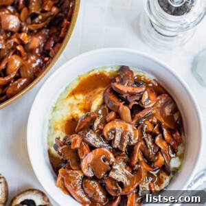 Elegant Mushrooms Bourguignon served generously in a white ceramic bowl, showcasing rich, dark sauce and tender mushrooms.