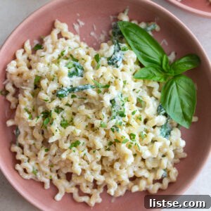 Weekly Meal Plan 23 3 A bowl of creamy ricotta pasta topped with fresh herbs and parmesan cheese, ready for a quick and delicious dinner.