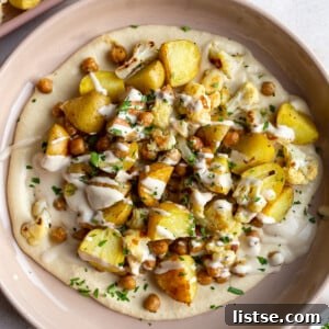Roasted Potato, Chickpea, and Cauliflower Bowls with a vibrant mix of vegetables and a creamy sauce