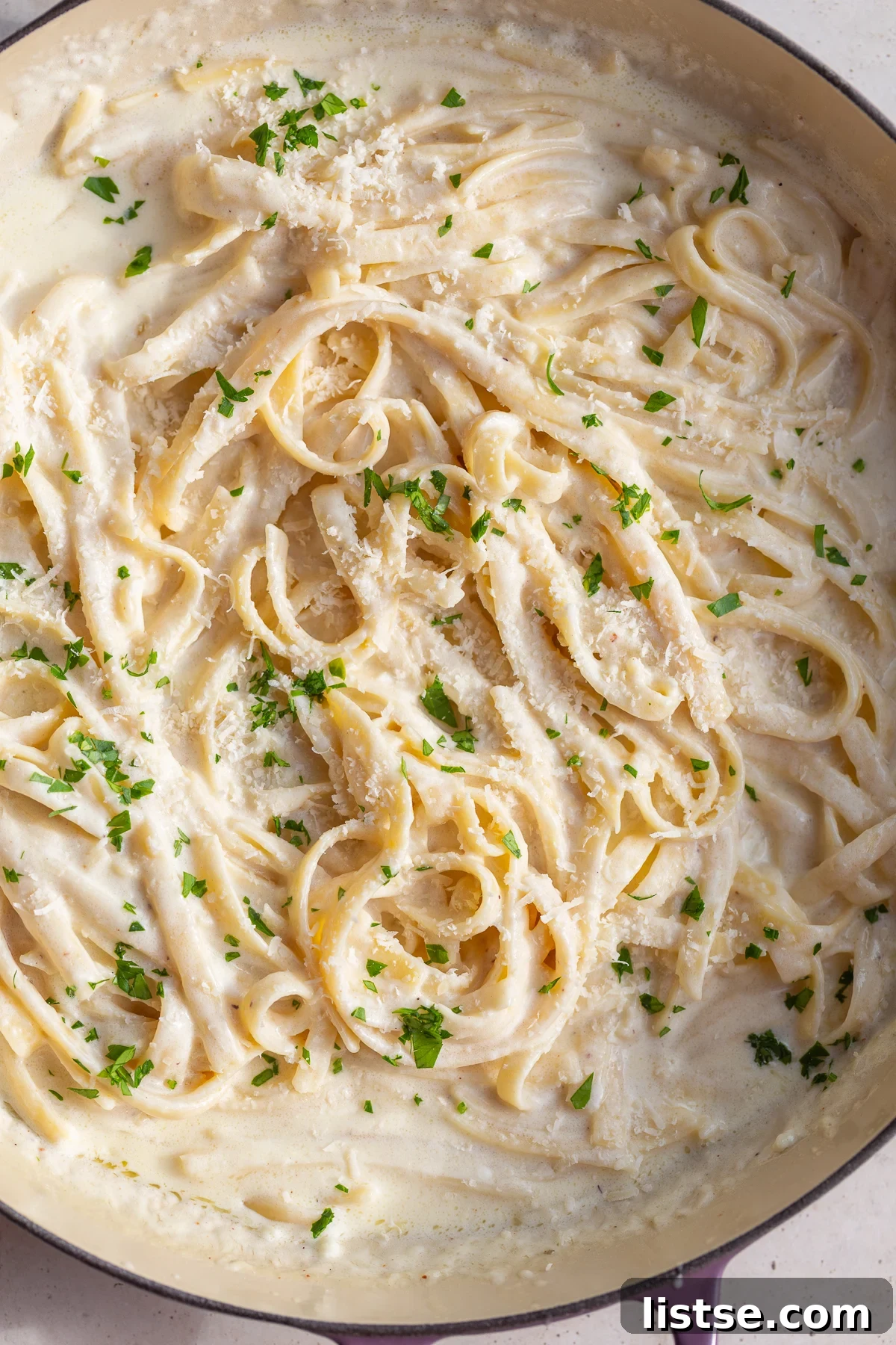 Luscious Homemade Alfredo in Minutes 8 A delicious plate of homemade fettuccine alfredo, showcasing the rich and creamy texture of the sauce.