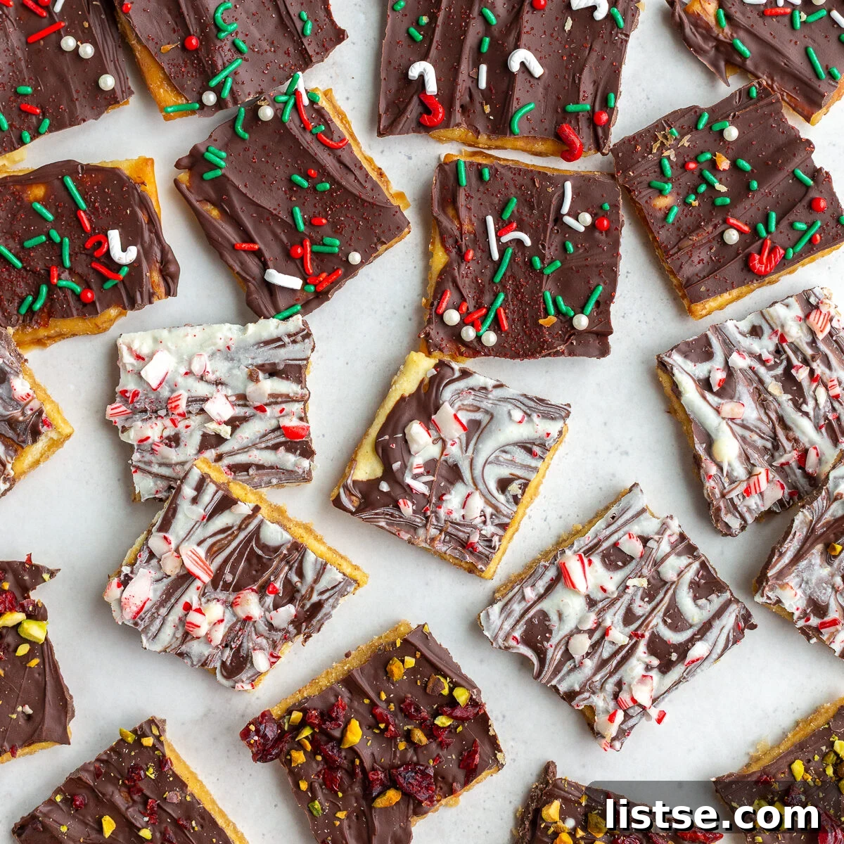 christmas crack recipe with pieces of cristmas toffee torn into small pieces and topped with various holiday toppings