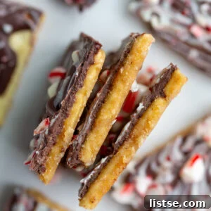 christmas cracker candy broken up into pieces and paying on it's side so you can see the cracker, toffee, and chocolate layers