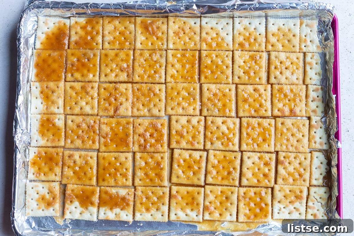 how to make christmas crack: picture of saltine toffee after being baked in the over
