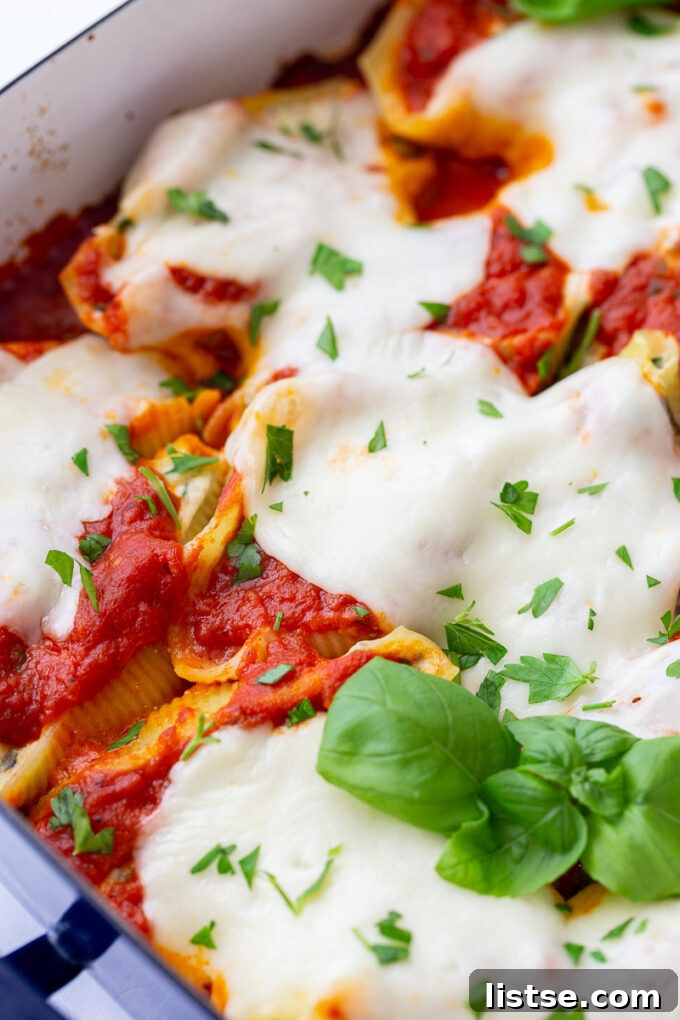 Creamy Spinach Ricotta Stuffed Shells 6 A close-up shot of a baked spinach and ricotta stuffed shell, showing the creamy filling and melted cheese.