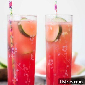 A refreshing Watermelon Cucumber Cocktail garnished with a cucumber ribbon and watermelon wedge.