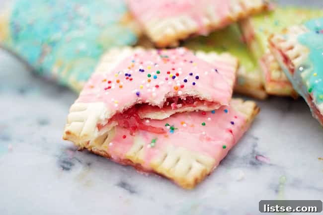 Assembling homemade strawberry pop tarts on a baking sheet