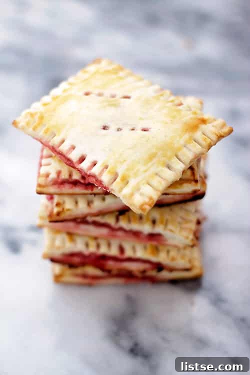Baked homemade strawberry pop tarts cooling on a rack