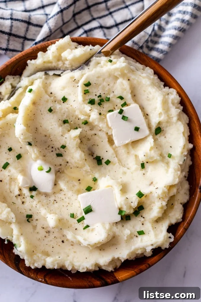 Velvety Slow Cooker Mashed Potatoes 2 Creamy crock pot mashed potatoes topped with melting pats of butter and fresh herbs