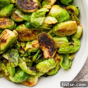 Quick and Crispy Sautéed Brussels Sprouts 11 Sautéed Brussels sprouts in a white serving bowl, a delectable and simple side dish.