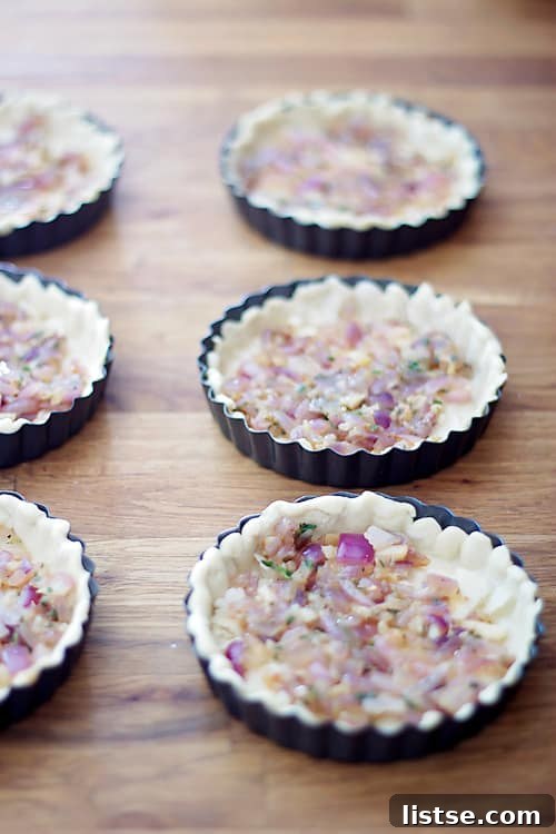 Goat Cheese and Thyme Tarts Filling puff pastry shells with caramelized onion mixture and Parmesan