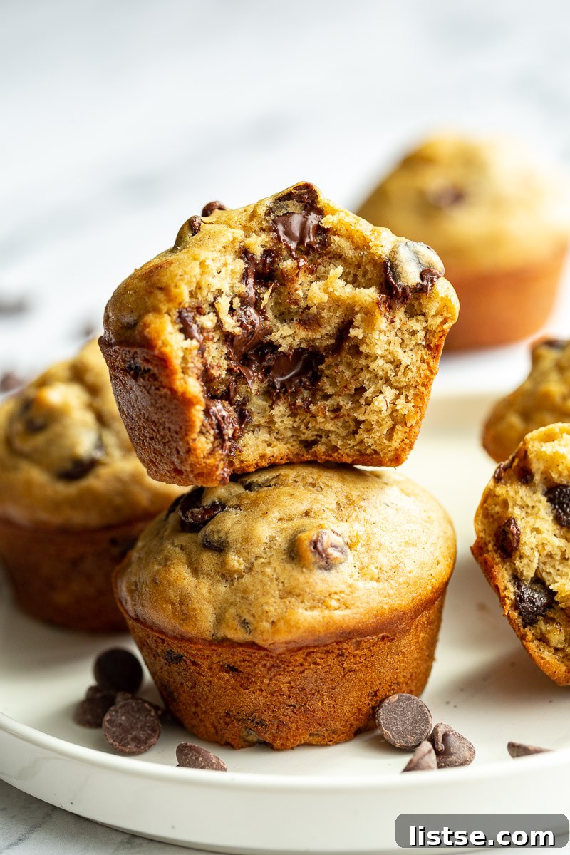 Plant-Powered Chocolate Chip Delights 10 A stack of warm vegan chocolate chip muffins with melted chocolate chips