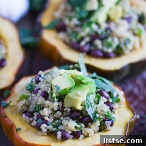 acorn squash cut in half and stuffed with quinoa and black beans. topped with avocado and herbs