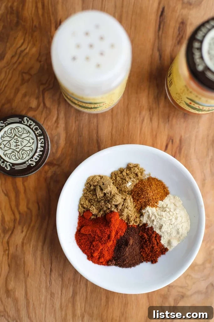 Authentic Enchilada Sauce from Scratch 3 A top-down shot showcasing the essential spices for homemade enchilada sauce: vibrant chili powder, earthy cumin, pungent garlic powder, and a touch of mysterious espresso powder.