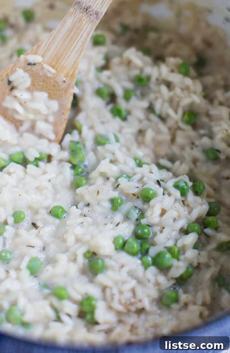 A bowl of freshly cooked Spring Pea & Goat Cheese Risotto with melted cheese.
