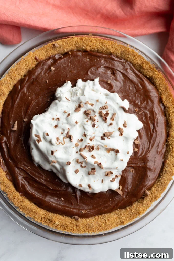 Chocolate Peanut Butter Pie topped with coconut whipped cream.
