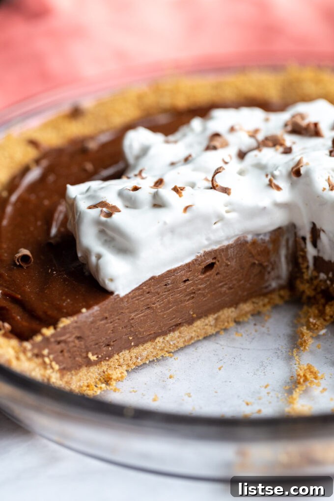 Peanut butter chocolate pie that has a slice removed.
