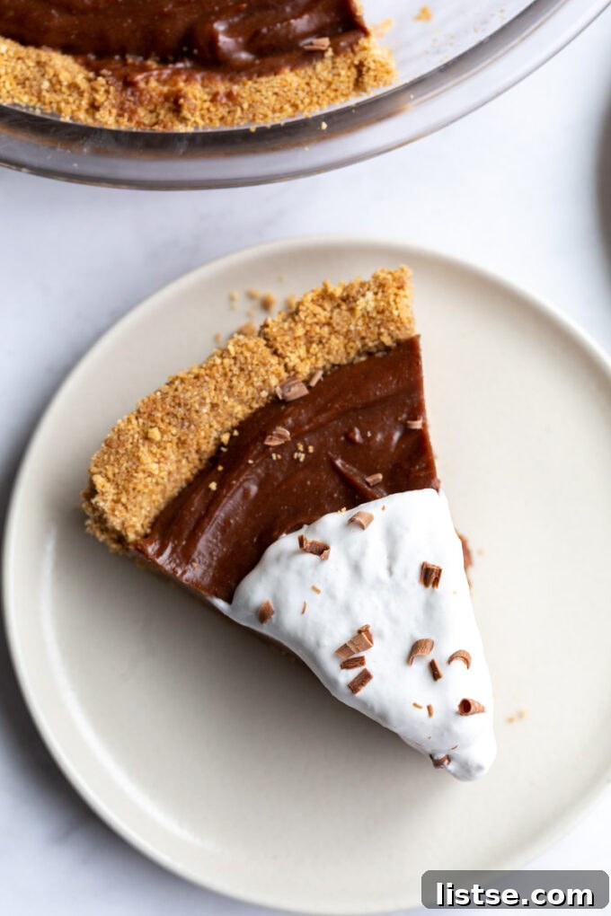 Slice of chocolate peanut butter pie on a white plate.