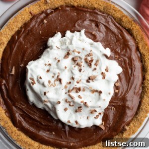 Chocolate Peanut Butter Pie topped with coconut whipped cream.