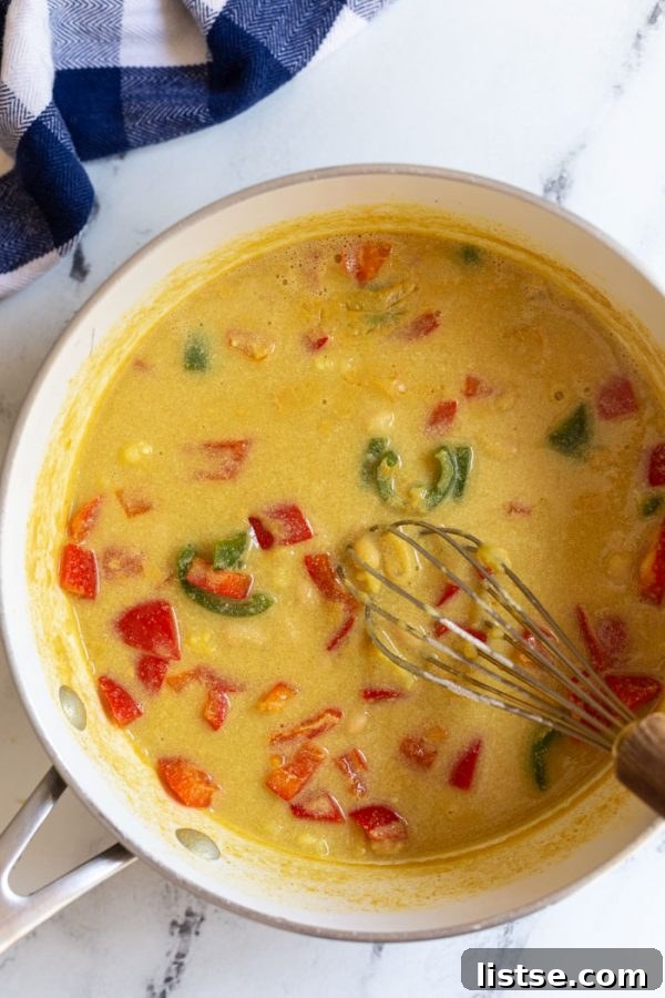 A vibrant selection of fresh ingredients for vegan nacho cheese sauce arranged on a surface.