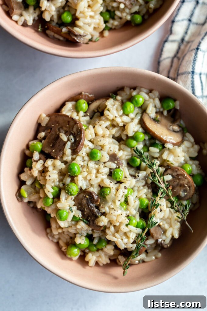 Quick and Creamy Vegan Risotto 4 bowl filled with risotto that has mushrooms and peas in it