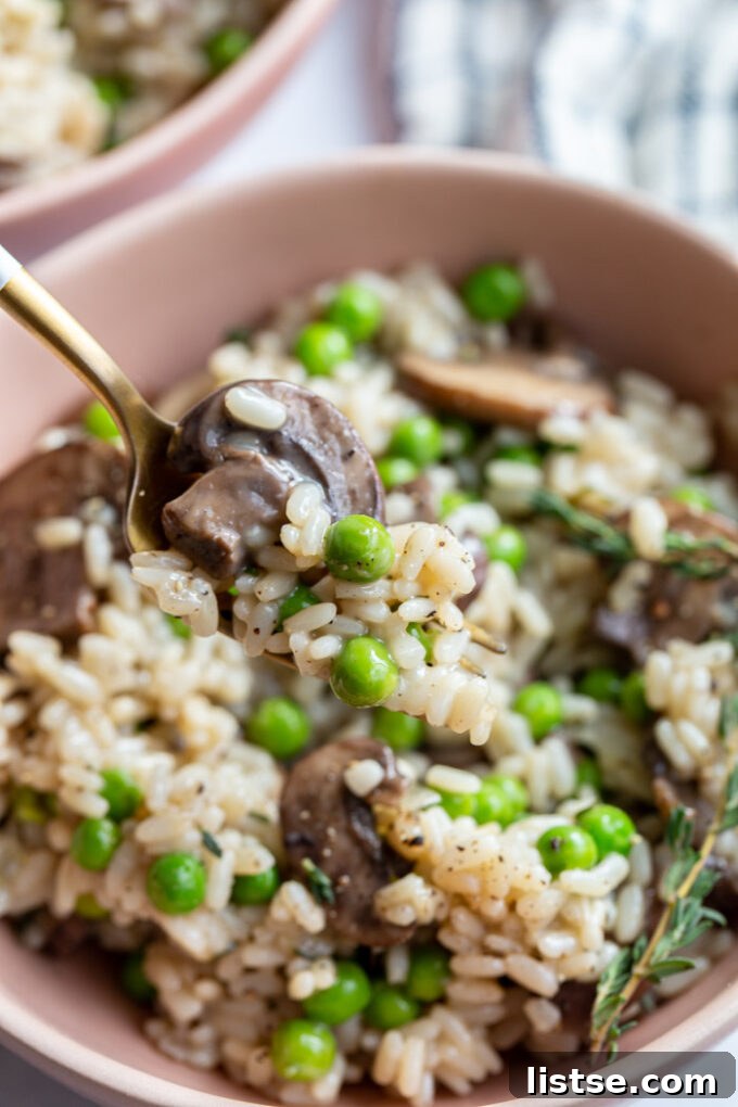 Quick and Creamy Vegan Risotto 7 fork full of vegan mushroom risotto