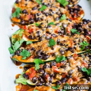 Close-up of baked Enchilada Zucchini Boats, garnished with fresh cilantro.
