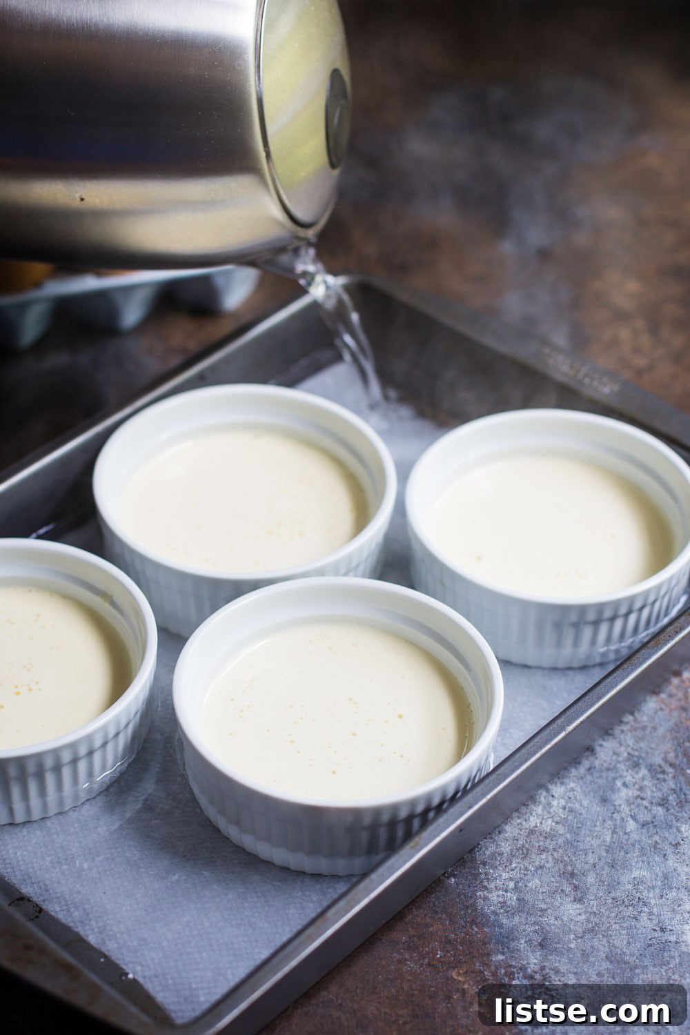Ramekins in a water bath, with hot water filling the baking dish halfway up the sides.