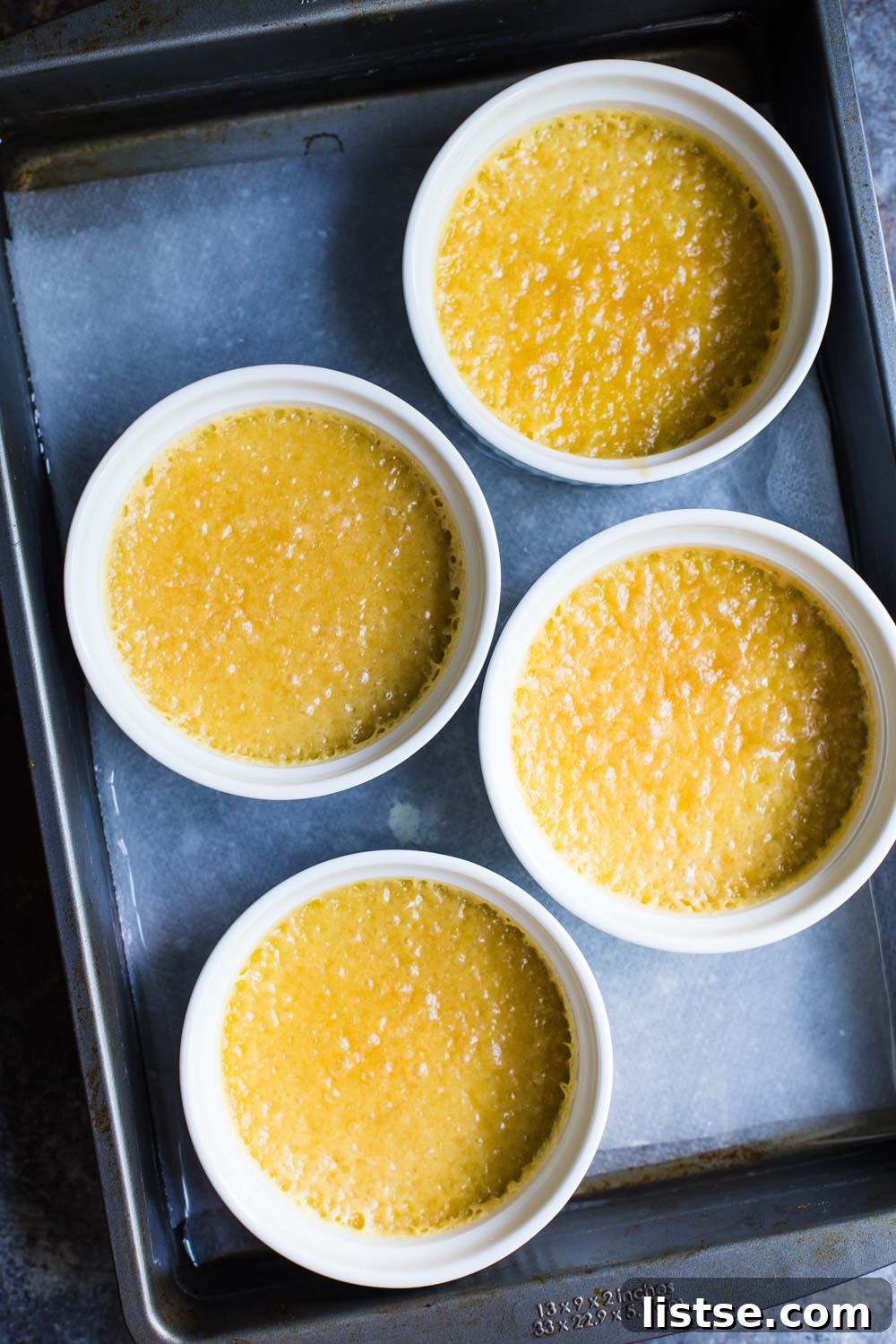Baked Dairy-Free Crème Brûlée ramekins just out of the oven, showing the jiggly texture.