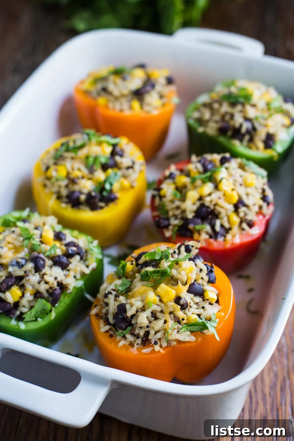 Loaded Burrito Stuffed Peppers 8 Finished vegan burrito bowl stuffed peppers garnished with cilantro, salsa, and vegan sour cream.