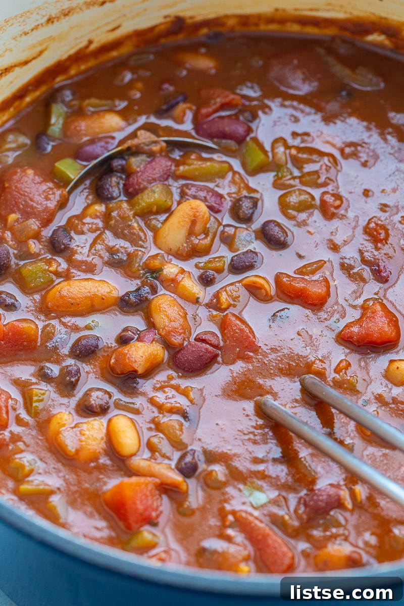 Ultimate Plant-Based Chili 3 Hearty vegetarian chili, made with a vibrant mix of beans, tomatoes, and vegetables, simmering beautifully in a large, inviting pot.