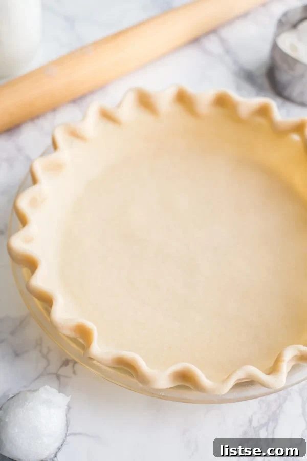 Exquisitely flaky coconut oil vegan pie crust, showcasing its golden-brown perfection and readiness for any filling