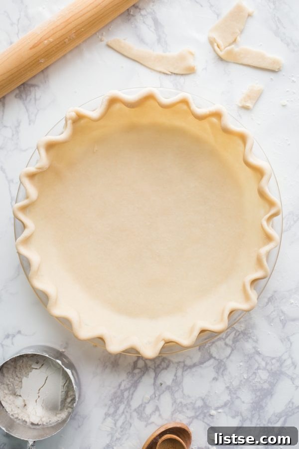 A stunning close-up of a golden, tender coconut oil vegan pie crust, emphasizing its perfectly baked and flaky texture