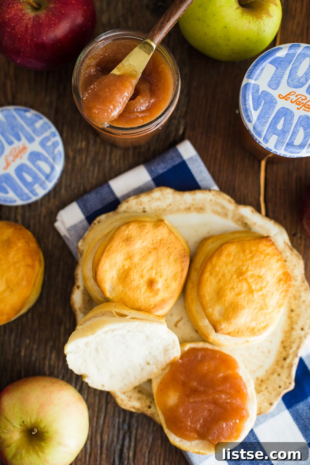 Two glass jars filled with homemade apple butter, tied with rustic twine.