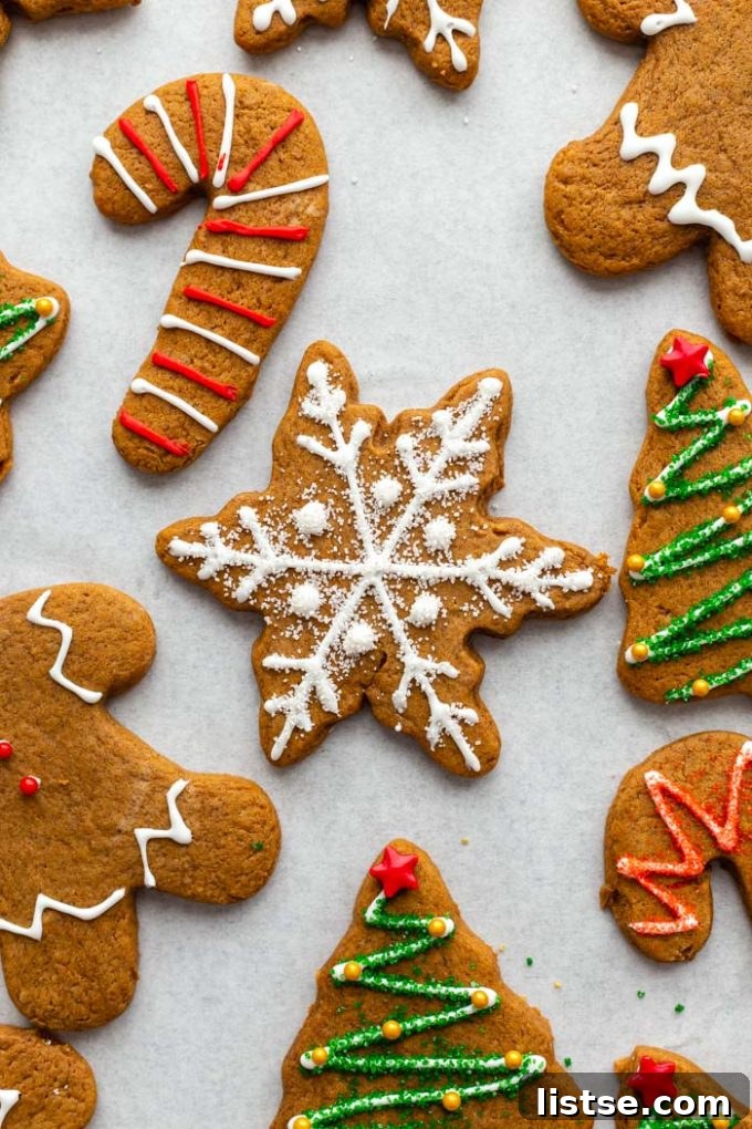 Plant-Based Gingerbread Delights 5 A perfectly baked vegan gingerbread cookie in the shape of a snowflake, with gently browned edges and a soft center, cooling on a parchment-lined baking sheet.