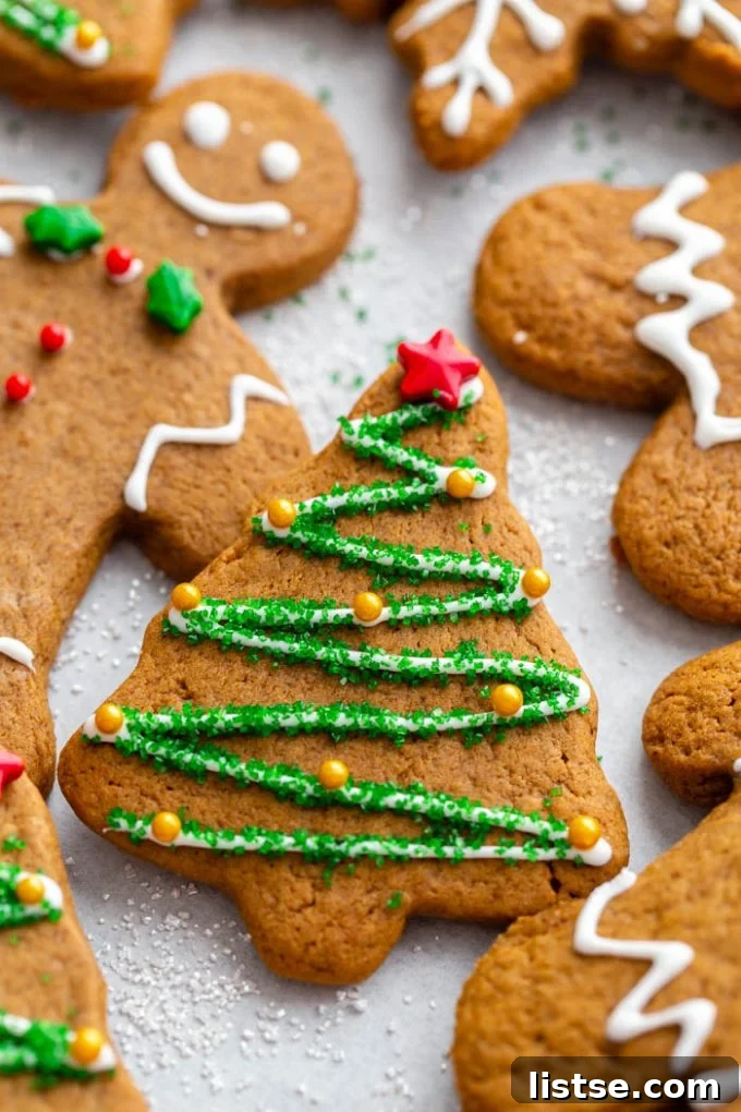 Plant-Based Gingerbread Delights 7 A charming vegan gingerbread cookie shaped like a Christmas tree, beautifully decorated with delicate white icing and colorful star sprinkles, ready for festive celebrations.