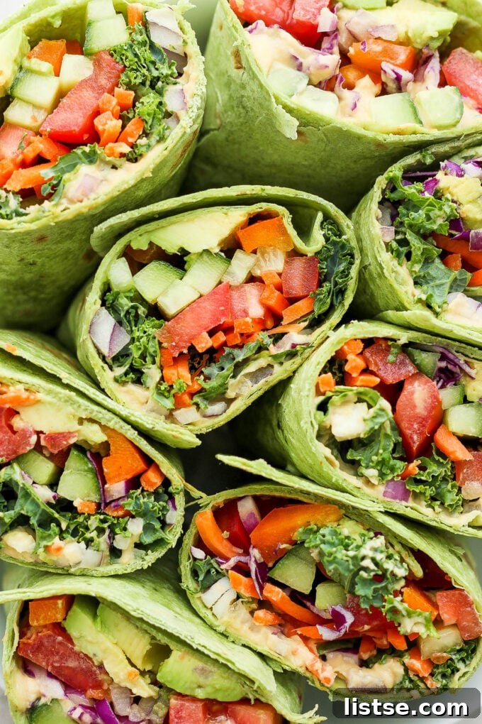 Fresh veggie wraps filled with creamy hummus and a rainbow of crisp vegetables, perfectly presented for a healthy meal.