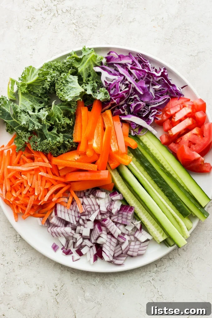 A colorful assortment of fresh vegetables, including carrots, bell peppers, and leafy greens, neatly prepped and ready for making healthy vegan wraps.