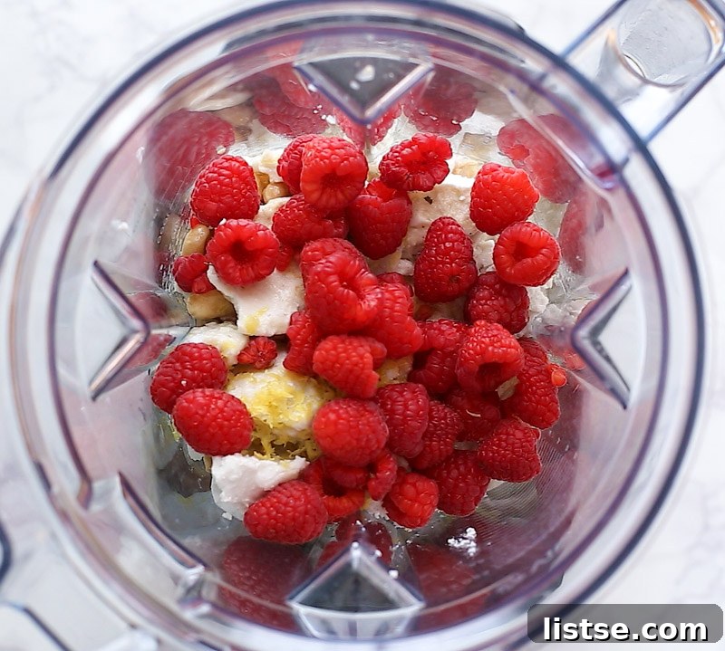 A close-up of the rich, vibrant raspberry filling being prepared in the Vitamix Ascent blender