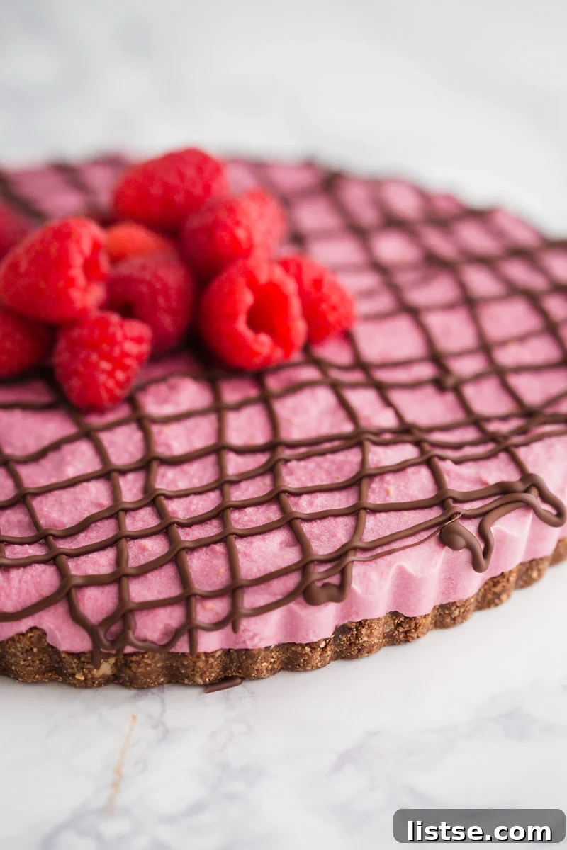 Close-up view of the smooth, rich filling of the Vegan Chocolate Raspberry Tart, showcasing its luscious texture