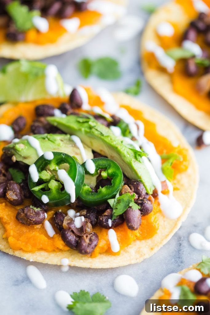 Vibrant Sweet Potato and Black Bean Tostadas 3 A close-up of a sweet potato and black bean tostada, showing the toppings and crispy shell