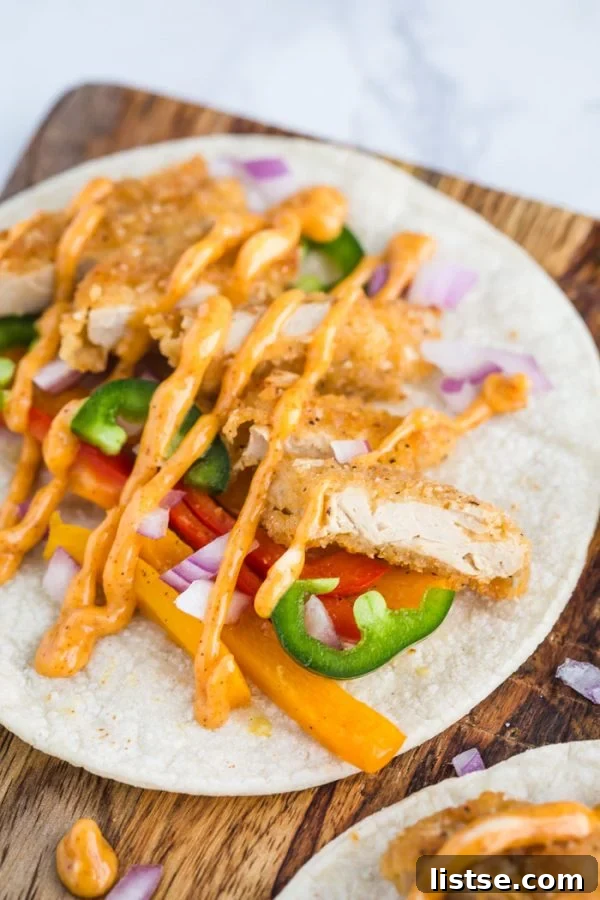 Crispy Vegan Chickn Tacos 8 Assembled Vegan Crispy Chick'n Tacos with spicy sauce and toppings