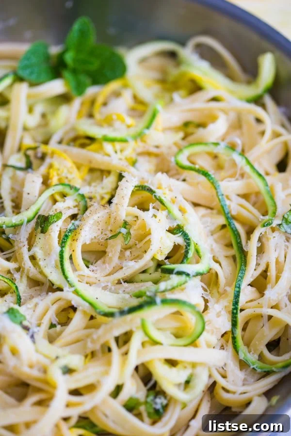 Zoodle Linguine 3 Closeup of Zucchini Linguine featuring vibrant green zucchini noodles and fresh mint leaves, a refreshing and quick vegetarian meal.
