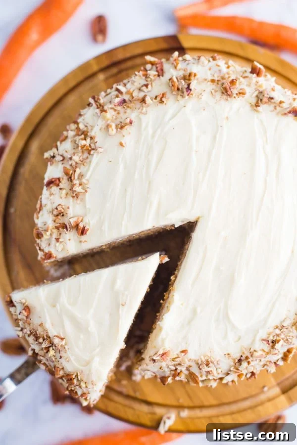 My Mother-In-Law's Foolproof Carrot Cake 3 Close-up of a slice of Easy Carrot Cake with fluffy cream cheese frosting, highlighting the texture and inviting presentation.