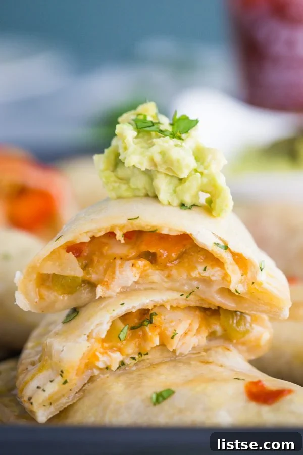 close-up of a chicken empanada recipe, showing the golden crust and bubbling cheesy filling inside