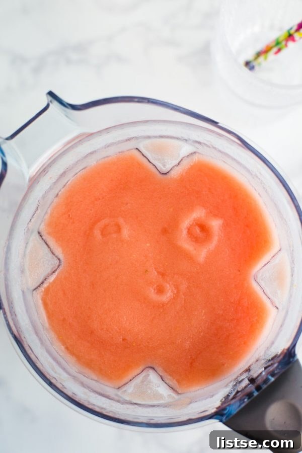 Top-down view of a blender filled with a vibrant Watermelon Wine Slushie
