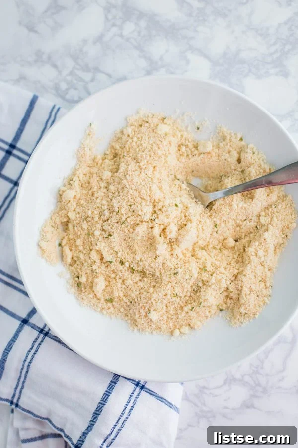Preparing the almond flour and Parmesan breading mixture for Keto Chicken Parmesan.