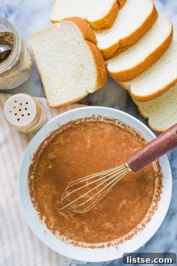 Top-down view of essential ingredients for vegan French toast: thick slices of bread, a bowl of ground flaxseed meal, a shaker of cinnamon, and a shallow bowl containing the whisked non-dairy milk and spice mixture.