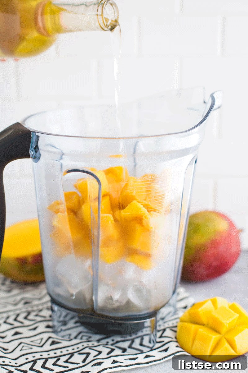 Animated GIF showing a mango wine slushie being poured into a glass.