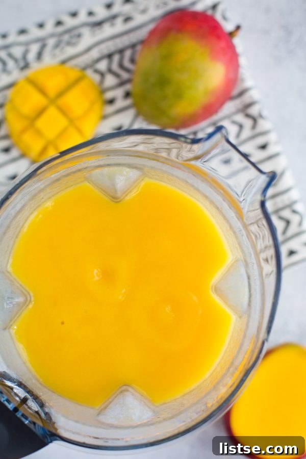 Close-up of a refreshing Mango Wine Slushie in a glass, ready for a summer party.